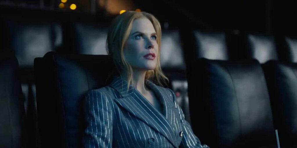 Woman sitting alone in a dark movie theater